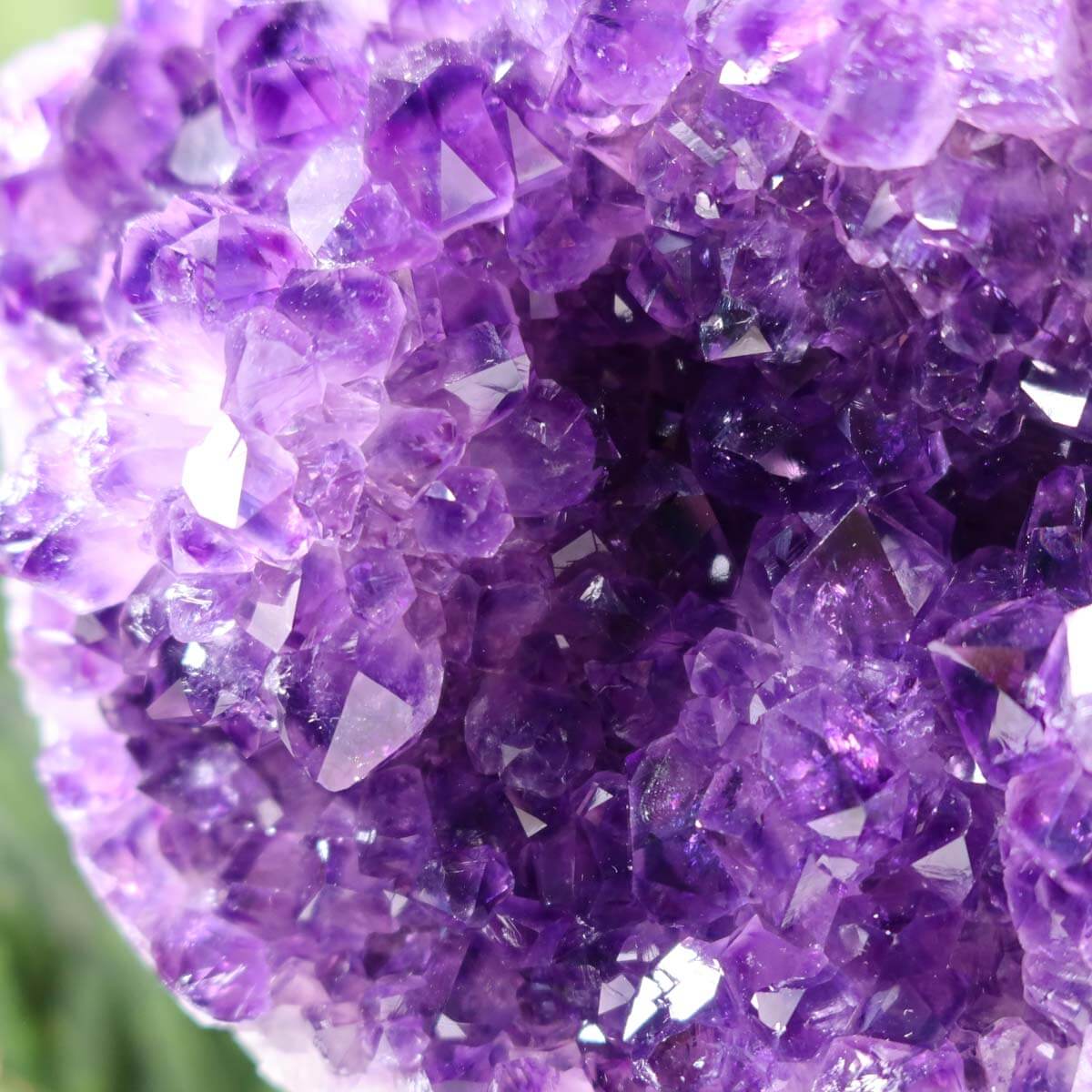 Close-up view of an Amethyst Druse from Uruguay showcasing deep purple crystals with intense sparkle