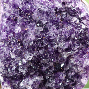 Close-up view of a dark purple Uruguay Amethyst Drusen showcasing its intense sparkle and natural crystal formations.