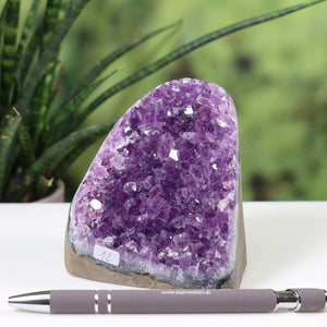 Intensely colored Uruguay Amethyst Mini Geode with natural crystals and dark purple tones, displayed with a pen for scale, unique item number 12.