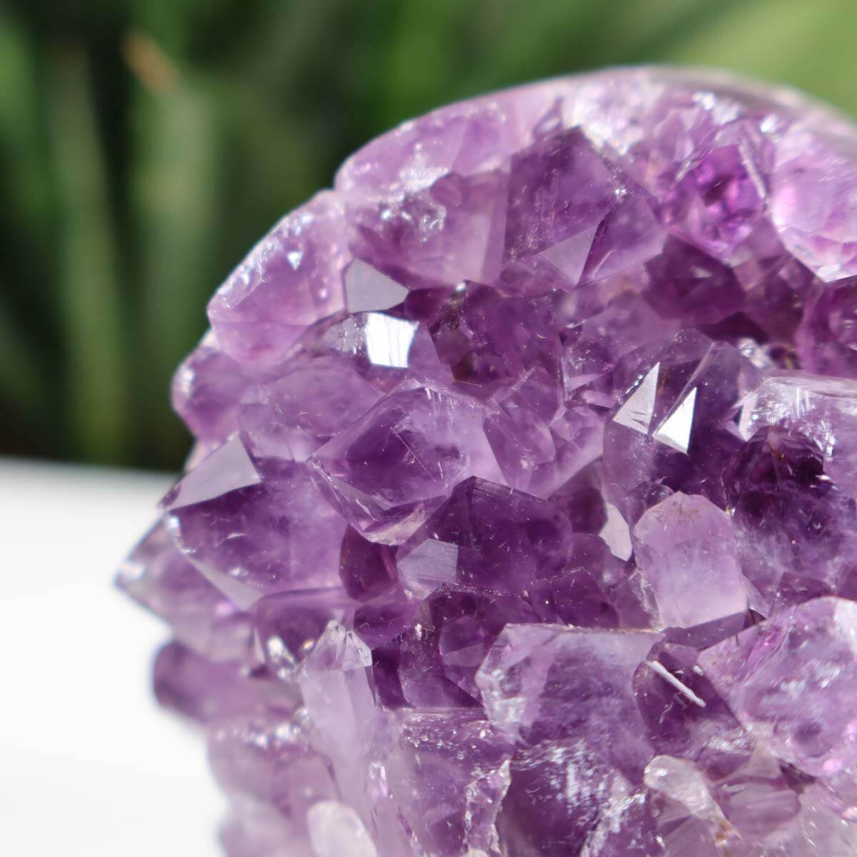 Uruguay Amethyst Mini Geode with intense purple crystals, labeled as unique piece number 15, displayed on a desk with a pen for scale.