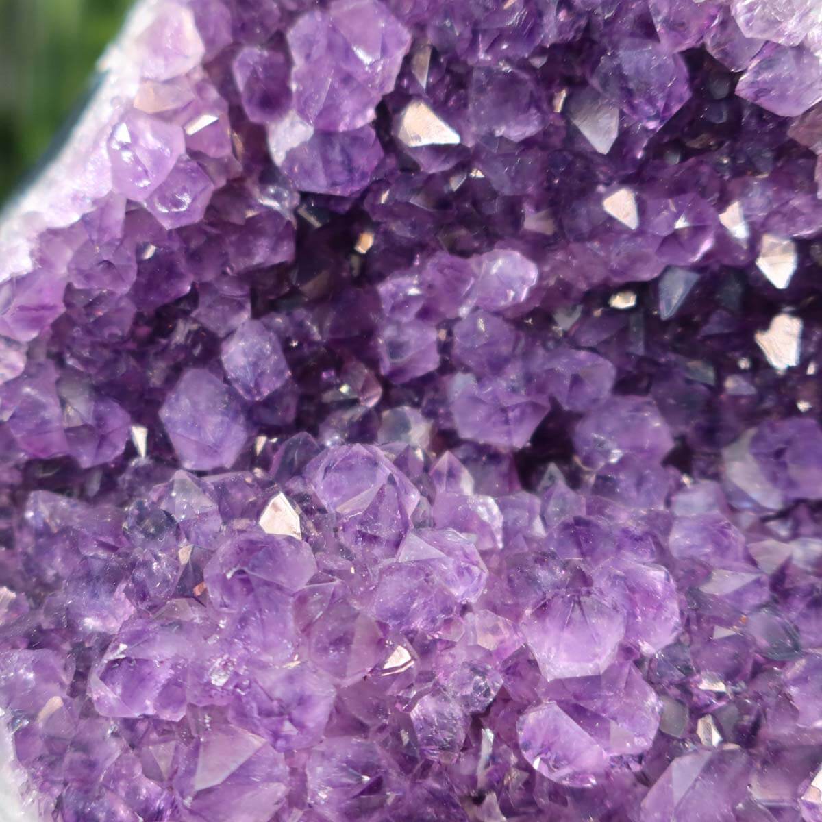 Close-up of a Uruguay Amethyst mini geode displaying intense purple crystals, unique specimen NR 18.