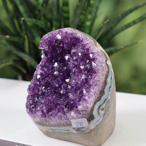 "Unikat NR 20 Uruguay Amethyst Mini Geode with intense violet crystals displayed on a white surface"