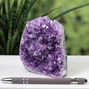 Uruguay Amethyst Mini Geode with intense violet crystals, displayed with a pen for scale, product number 22