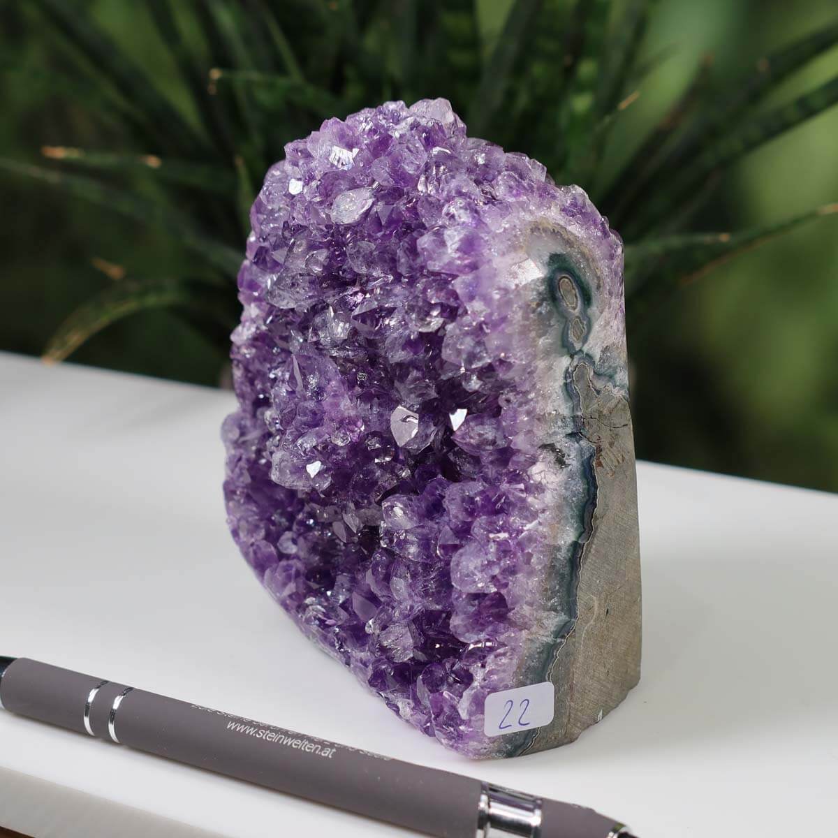 Uruguay Amethyst Mini Geode with intense purple crystals, unique piece number 22 displayed beside a pen for scale.