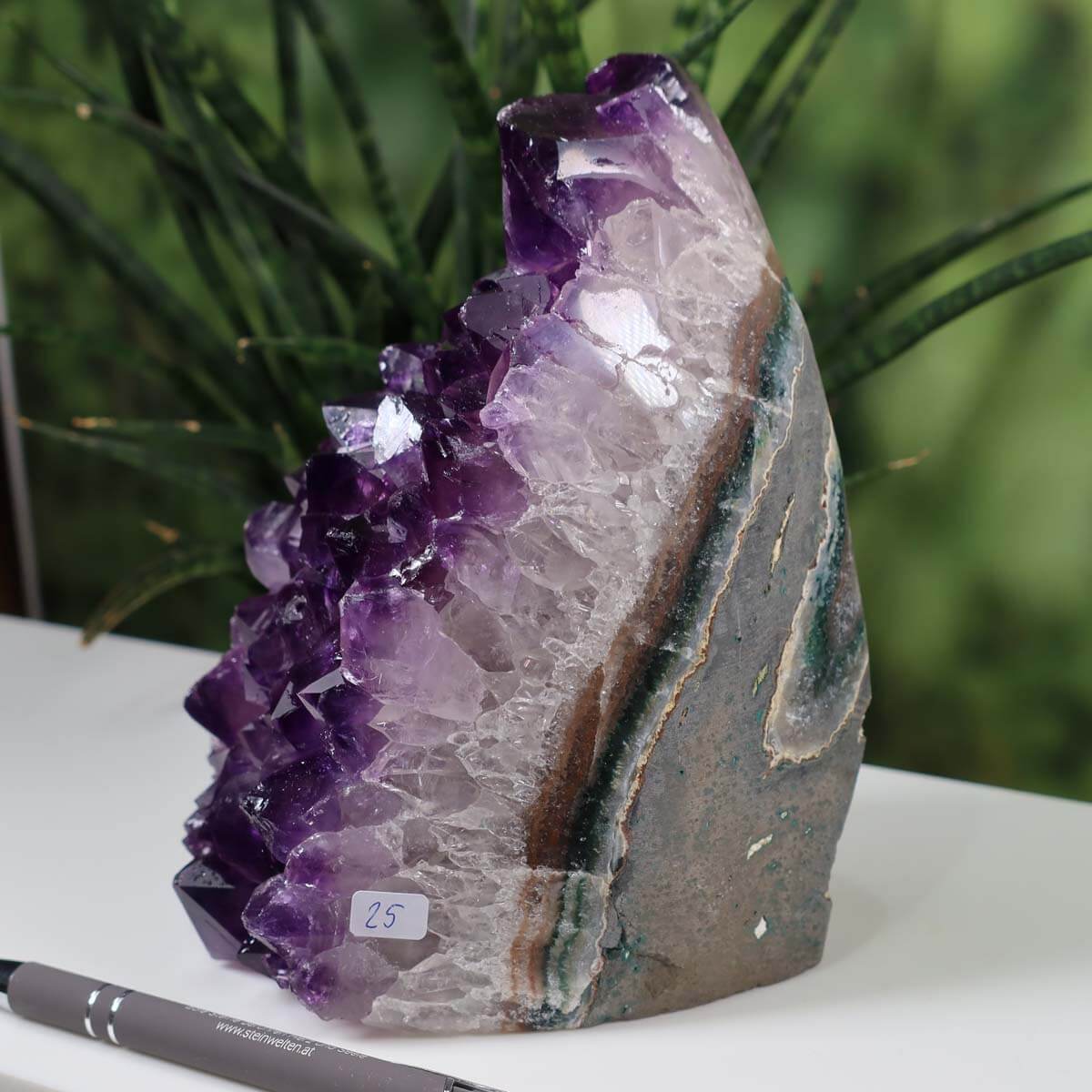 Intense purple Uruguay Amethyst mini geode number 25 displayed on a desk with natural background.