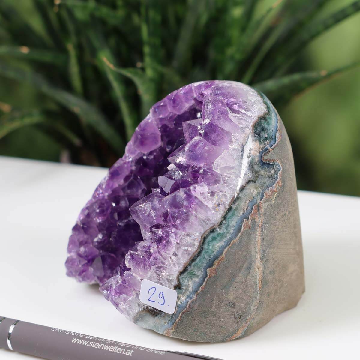 Uruguay Amethyst mini geode with intense purple crystals, labeled number 29, against a natural background.