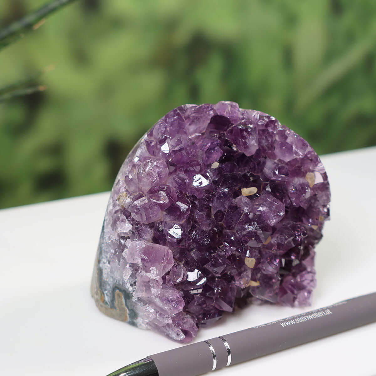 Uruguay Amethyst mini Geode NR-2 with intense purple crystals, displayed beside a pen for scale