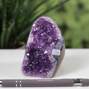 Uruguay Amethyst mini geode with intense purple crystals, unique item number 30, displayed on a desk with a pen for scale.