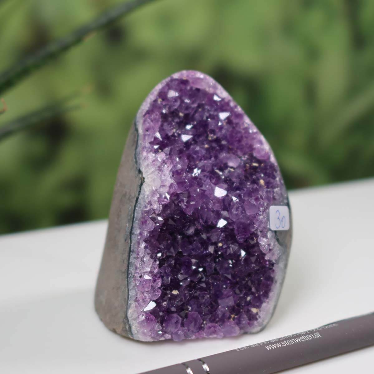 Uruguay Amethyst mini geode with intense purple crystals, unique item number 30, displayed on a desk with a pen for scale.