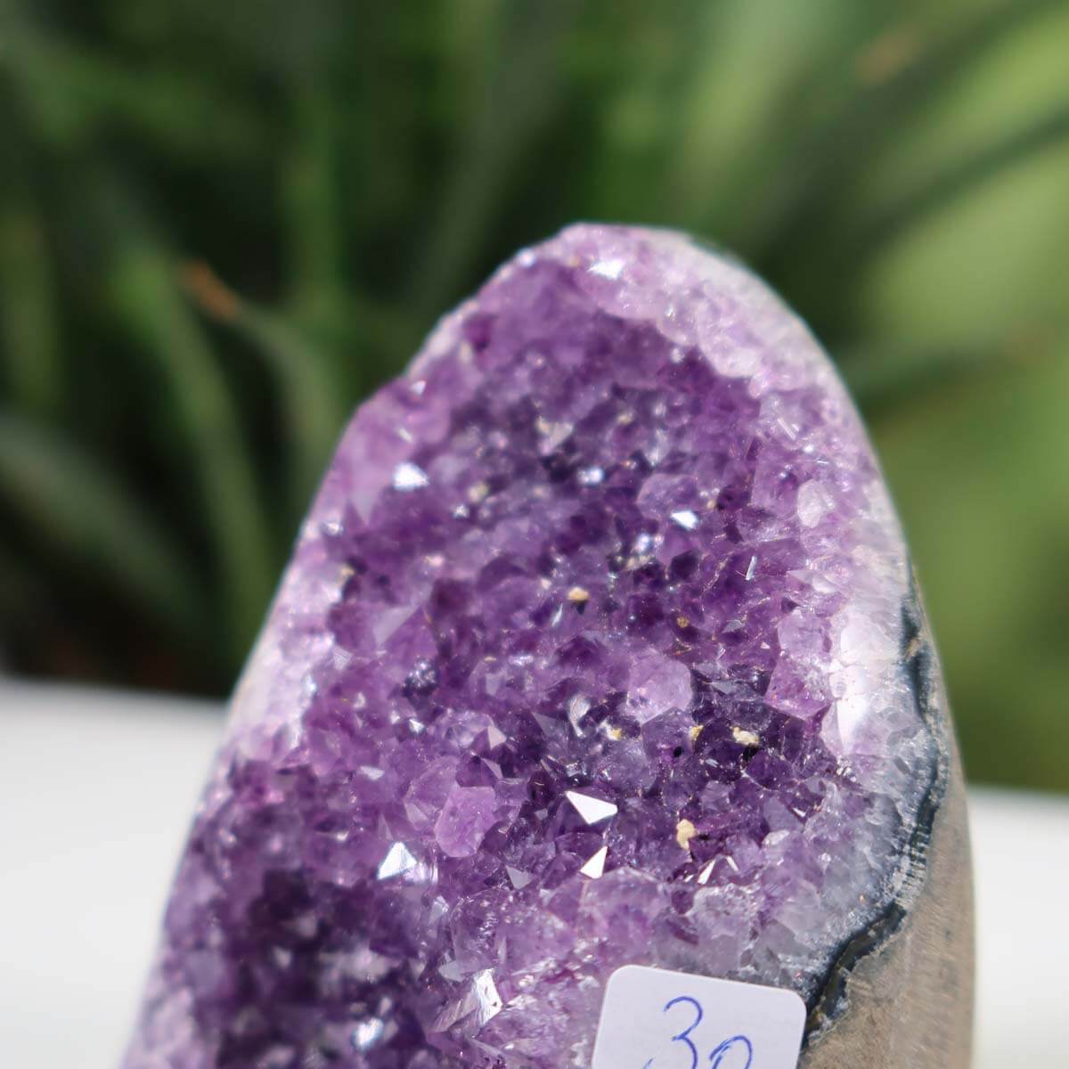 Close-up view of a Uruguay Amethyst Mini Geode, showcasing deep purple crystals, labeled as unique piece number 30.