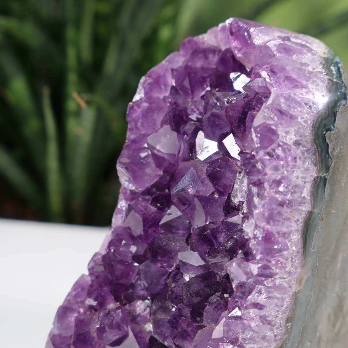 Close-up of a vibrant Uruguay Amethyst Mini Geode showcasing deep purple crystals with natural sparkle, Unikat NR 34.