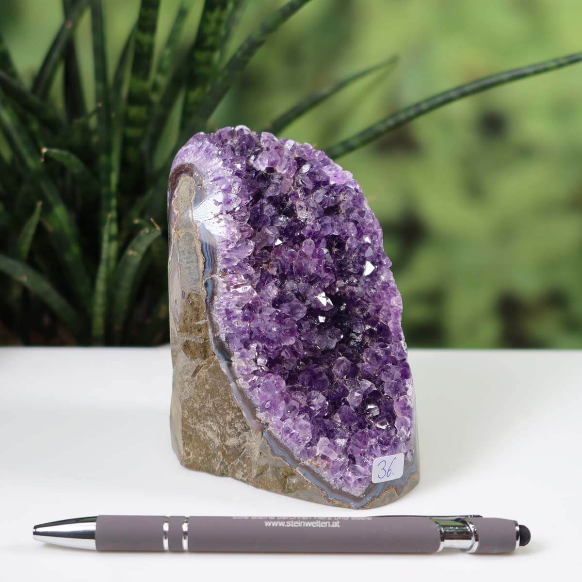 Uruguay Amethyst Mini Geode Unikat NR 36 with intense purple crystals displayed beside a pen for scale