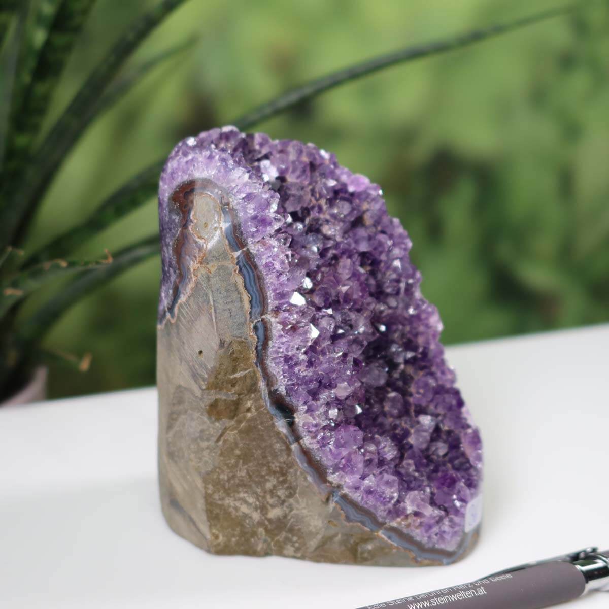 Uruguay Amethyst Mini Geode Unikat NR 36 with intense purple crystals displayed beside a pen for scale