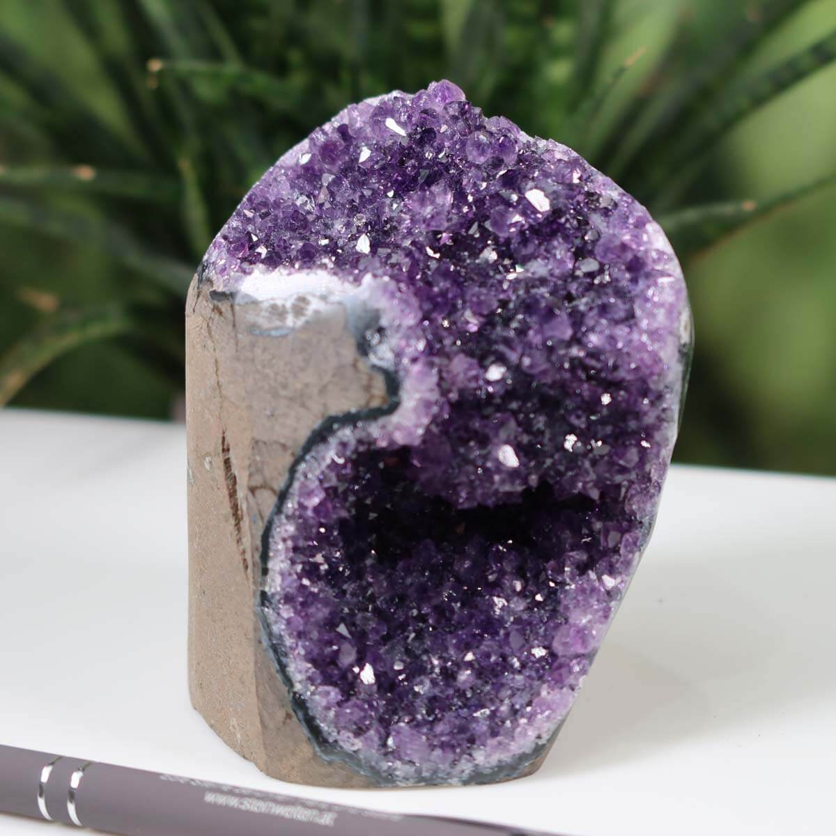 Uruguay Amethyst Mini Geode with intense purple crystals, showcased in natural setting, Unikat NR 37