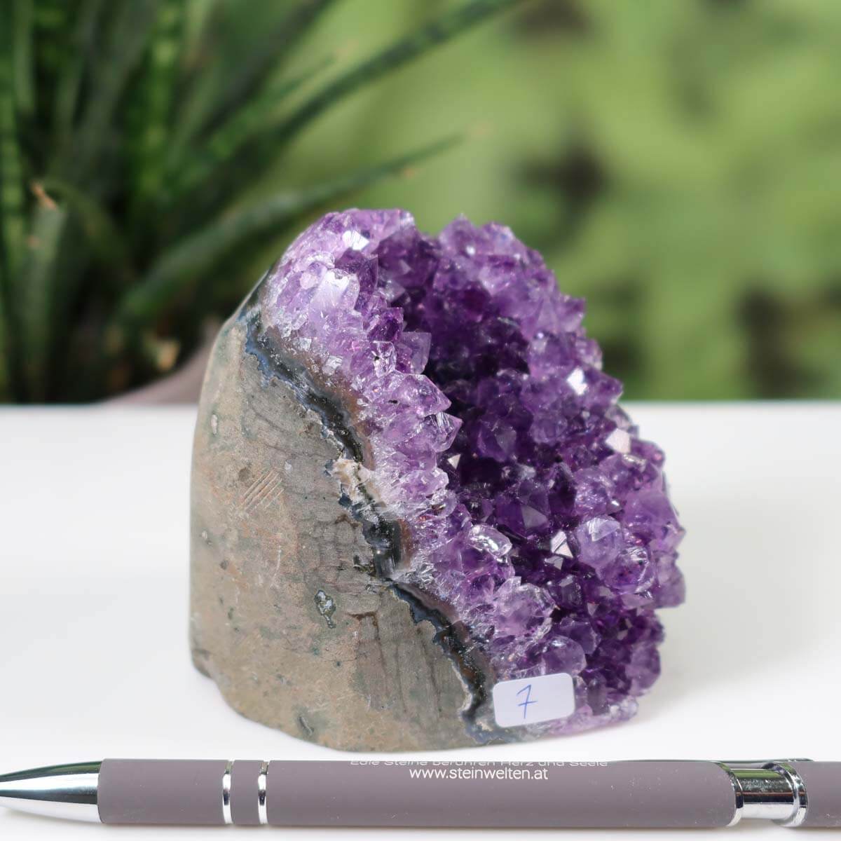 Intense purple Uruguay Amethyst mini geode displayed with a pen for scale, labeled as unique piece number 7.