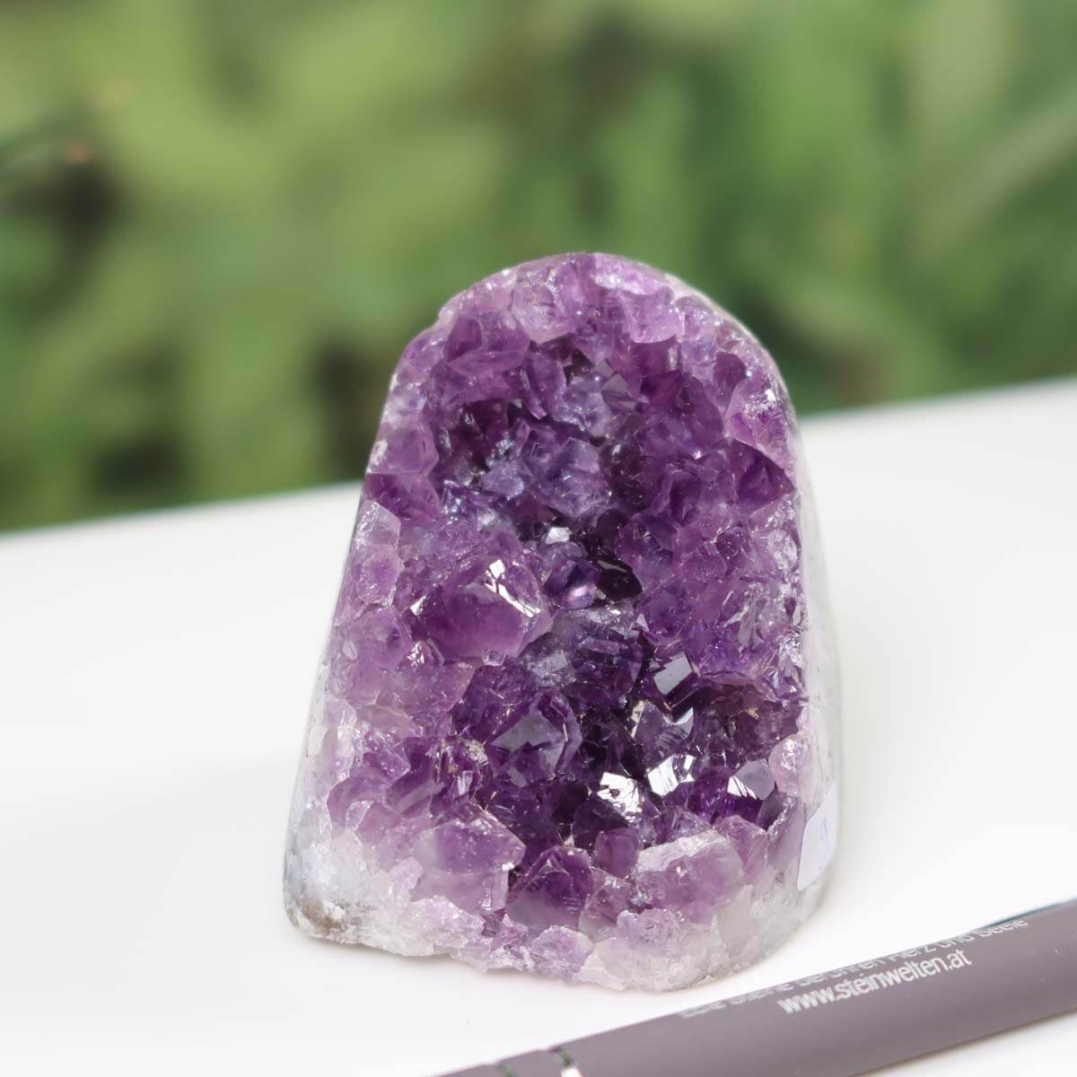 Intense purple Uruguay Amethyst mini geode with crystal clusters, unique piece labeled NR 9, displayed with a silver pen.