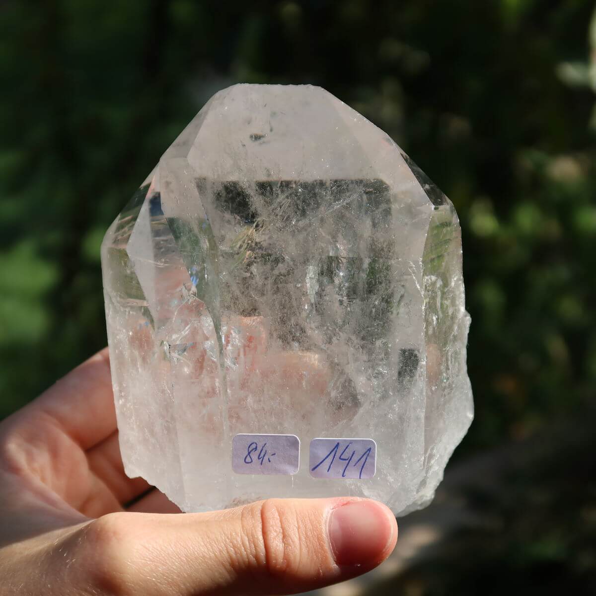 Clear quartz crystal point from Brazil, unique cut for clarity and meditation, 10x8 cm, hand-held with natural sparkle.