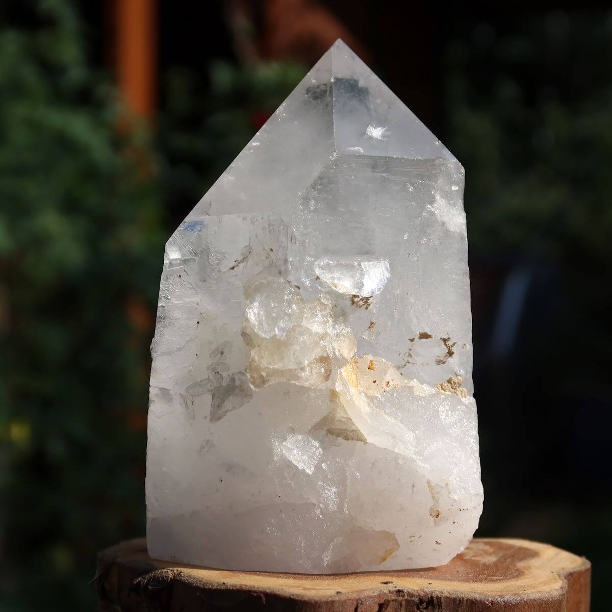 Polished quartz crystal point, unique specimen No. 150 from Brazil, stands on wood, perfect for clarity and meditation.