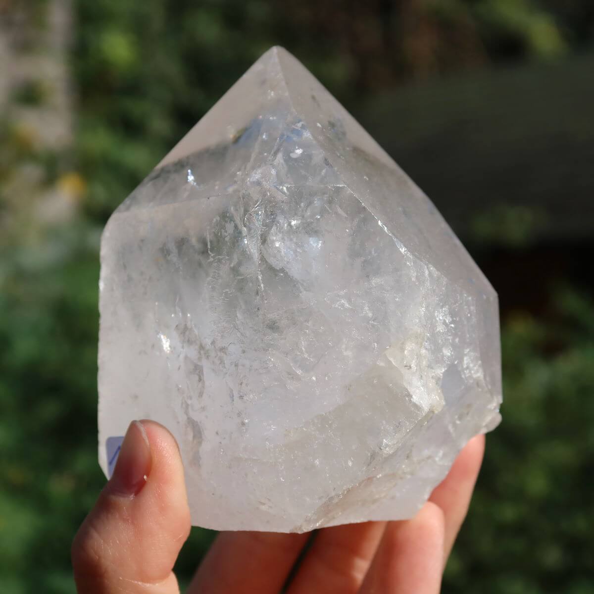 Clear quartz crystal point, hand-held, with unique faceted surfaces for meditation, size 8x7 cm, Brazil origin, product no. 152.