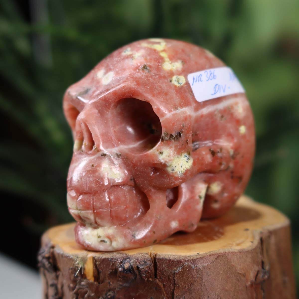 Handcrafted crystal skull made from natural stone with unique patterns, collectible skull measuring 7x6 cm, product number 386.