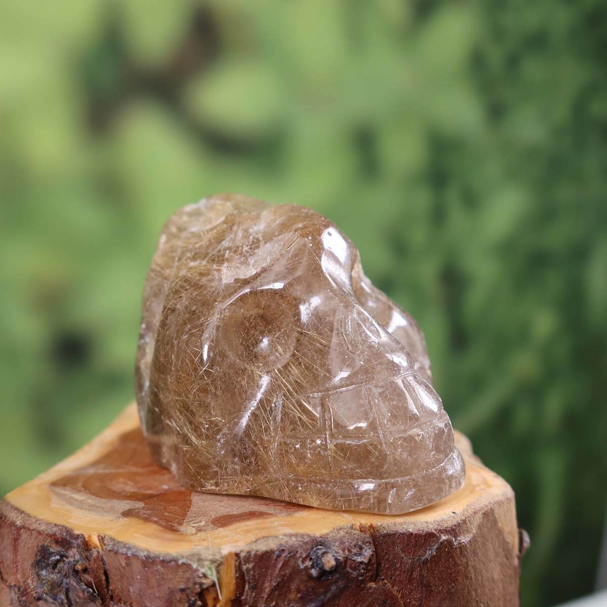 Handcrafted rutilated quartz crystal skull, unique mineral collectible from Steinwelten, on wooden base, 6x5 cm, Nr. 324