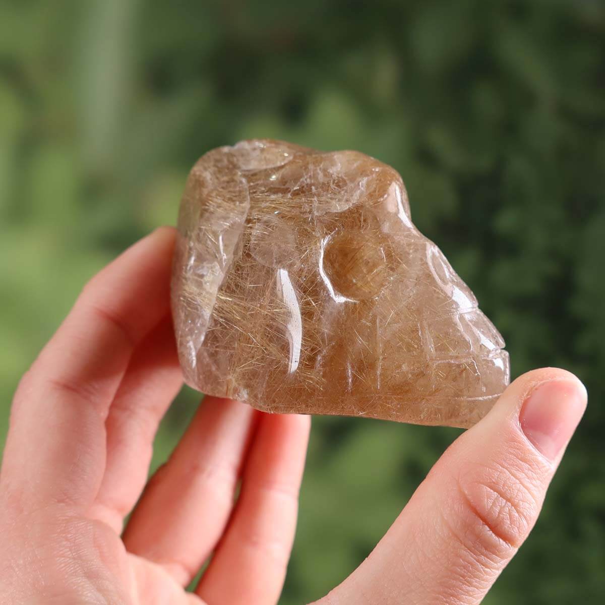 Handcrafted Rutilquarz crystal skull, unique gemstone sculpture, 6x5 cm, rare collector's piece, featuring mineral textures.